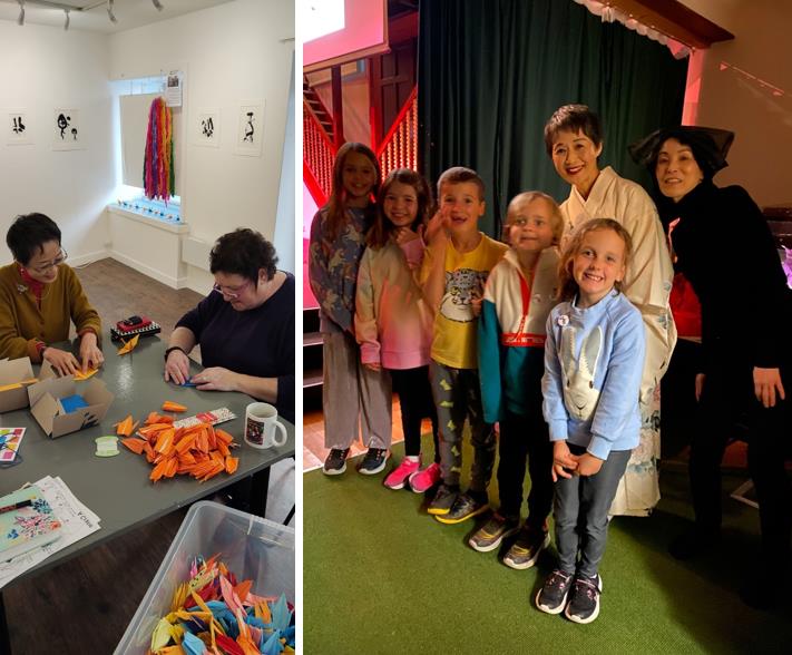Kids and grownups folding cranes