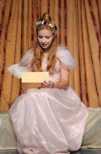 Beauty reads in the play Beauty and the Beast