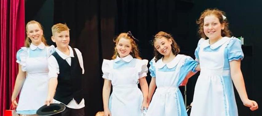 Several girls play Alice in Christmas Play